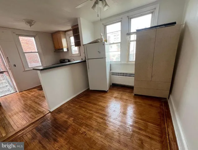 a kitchen with a refrigerator and a stove top oven