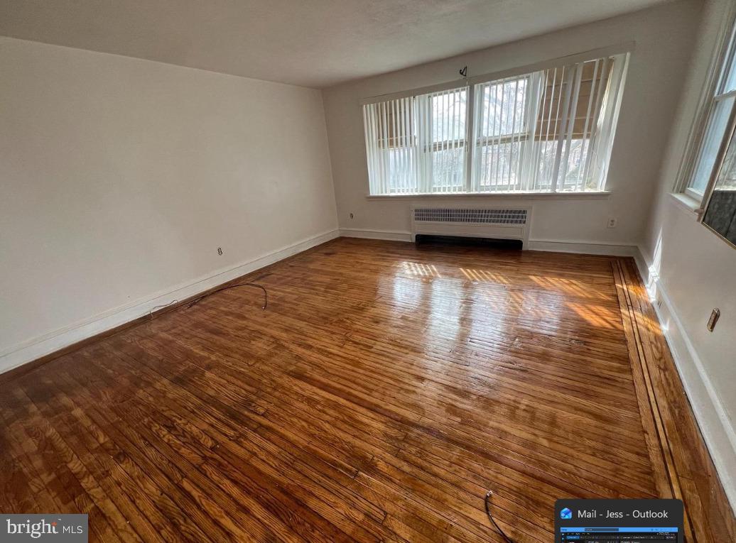 1933 71st Avenue Philadelphia, PA 19138 - Photo 6 of 6 wooden floor in an empty room with a window
