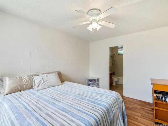 a bedroom with a bed and a tv