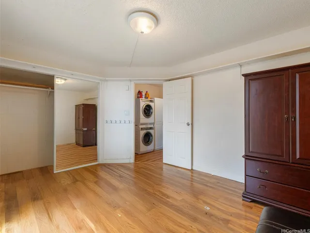 a view of an empty room and wooden floor