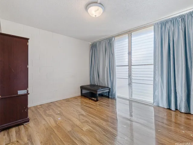 a view of a room with a wooden floor and a window
