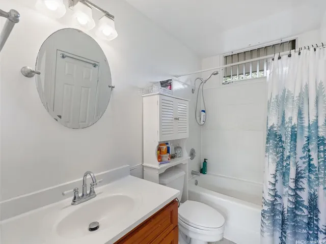 a white toilet sitting next to a bathroom sink