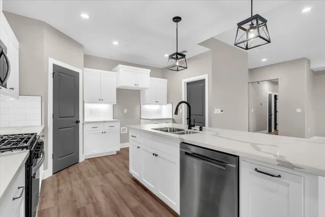 an aerial view of residential houses with outdoor space and trees