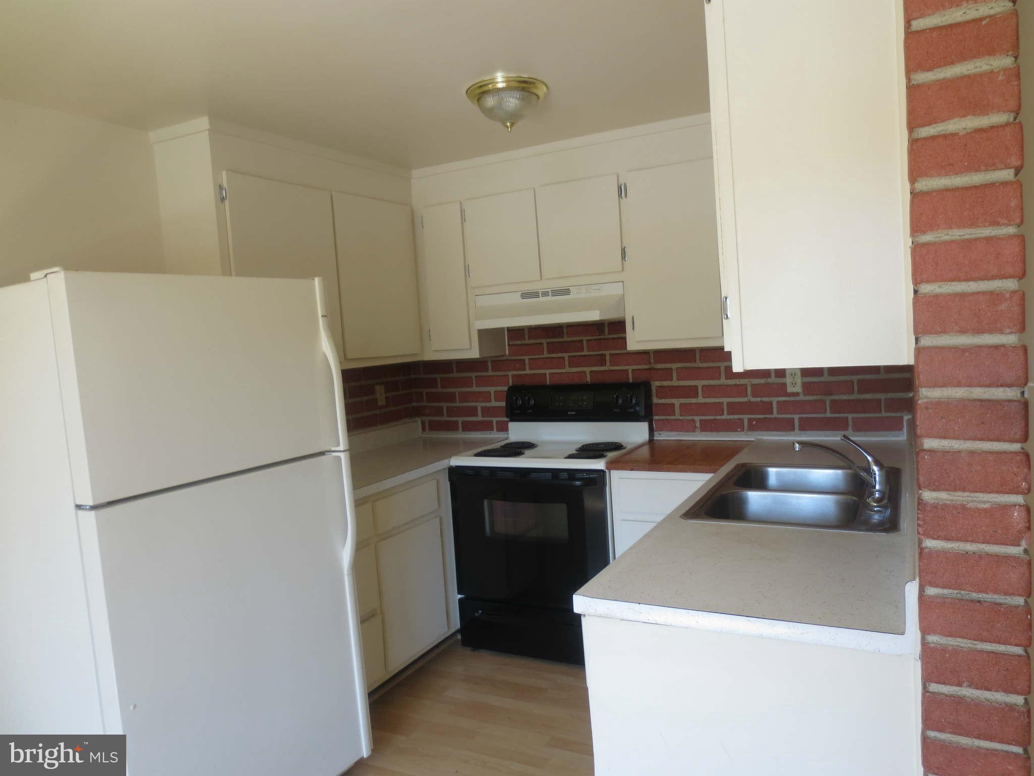 17530 Kohlhoss Road Poolesville, MD 20837 - Photo 3 of 17 a white refrigerator freezer and a stove sitting inside of a kitchen