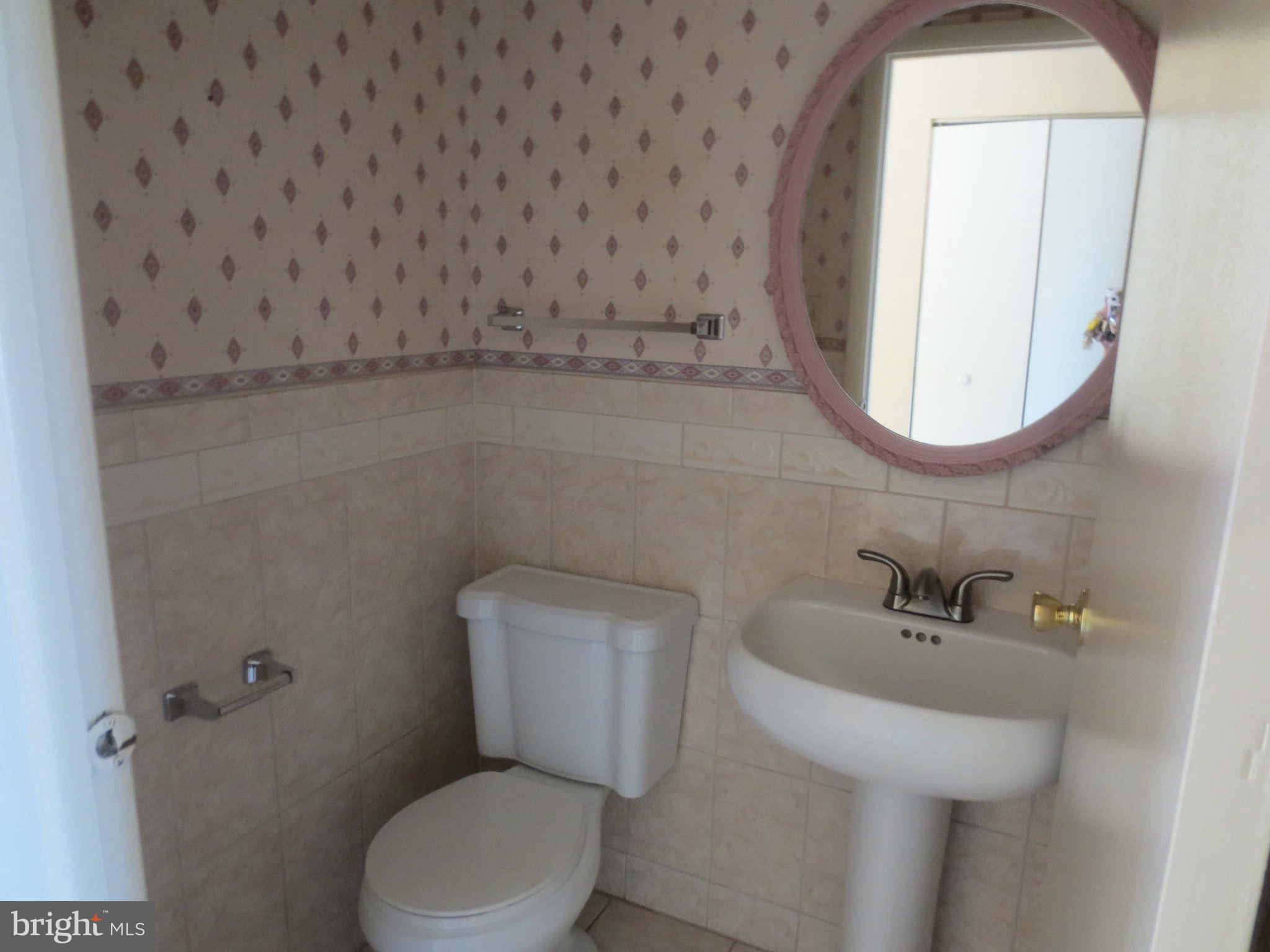 17530 Kohlhoss Road Poolesville, MD 20837 - Photo 9 of 17 a bathroom with a toilet a sink and a mirror