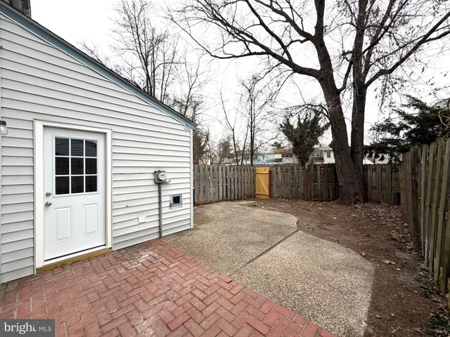 a view of a white house with a large tree
