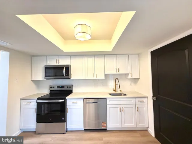 a kitchen with a sink stove and microwave