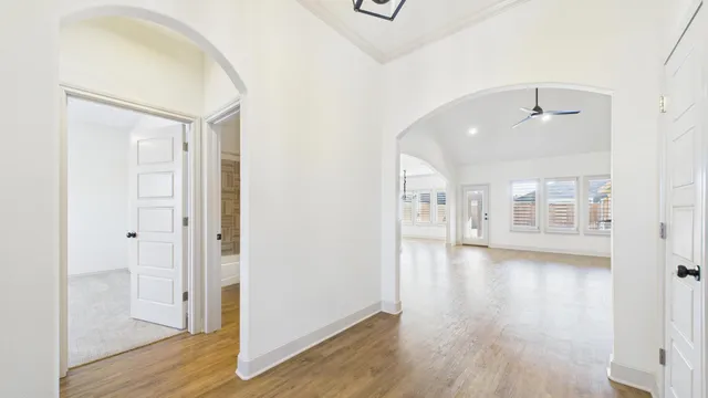 a view of empty room with floor to ceiling window and fireplace