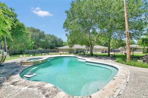 a kitchen with stainless steel appliances granite countertop a refrigerator a stove and a sink