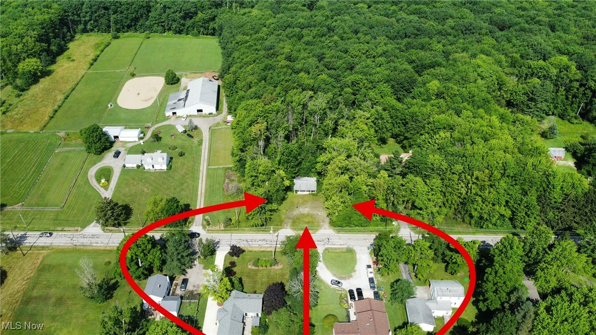 8552 Ravenna Road Chardon, OH 44024 - Photo 1 of 17 Aerial view of property and surrounding area featuring a heavily wooded area