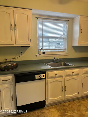 a view of a kitchen that has a sink and a stove