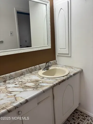 a bathroom with a sink and a mirror