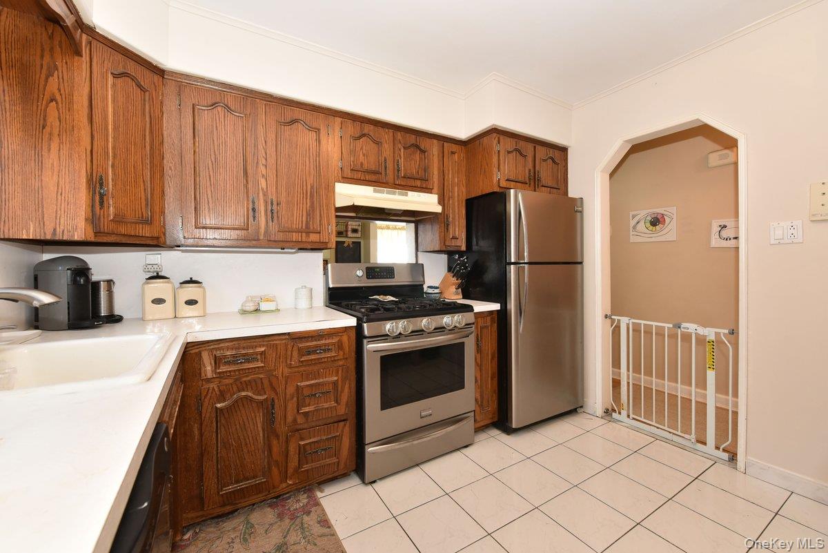 148 Simonson Road Mineola, NY 11501 - Photo 11 of 19 a kitchen with stainless steel appliances granite countertop a refrigerator sink and stove