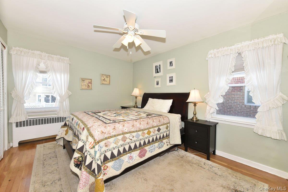 148 Simonson Road Mineola, NY 11501 - Photo 12 of 19 a bedroom with a bed and a chandelier
