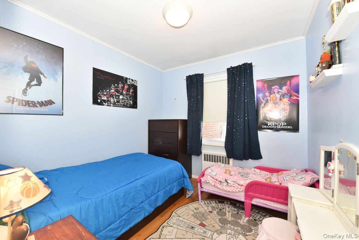 148 Simonson Road Mineola, NY 11501 - Photo 13 of 19 a bedroom with a bed and cupboard