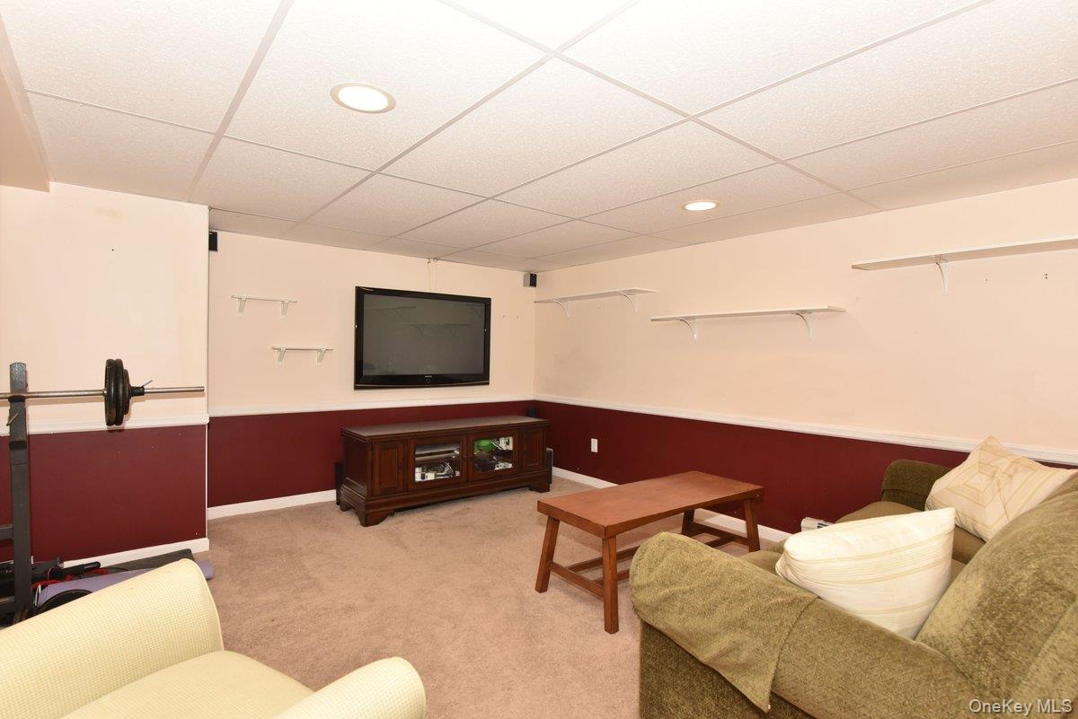 148 Simonson Road Mineola, NY 11501 - Photo 16 of 19 a living room with furniture and a flat screen tv