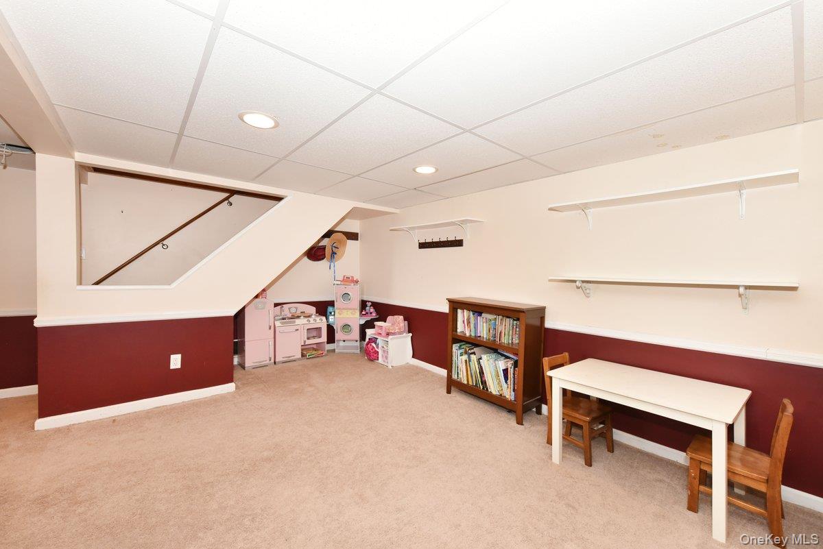148 Simonson Road Mineola, NY 11501 - Photo 17 of 19 a view of a room with stairs and a couch