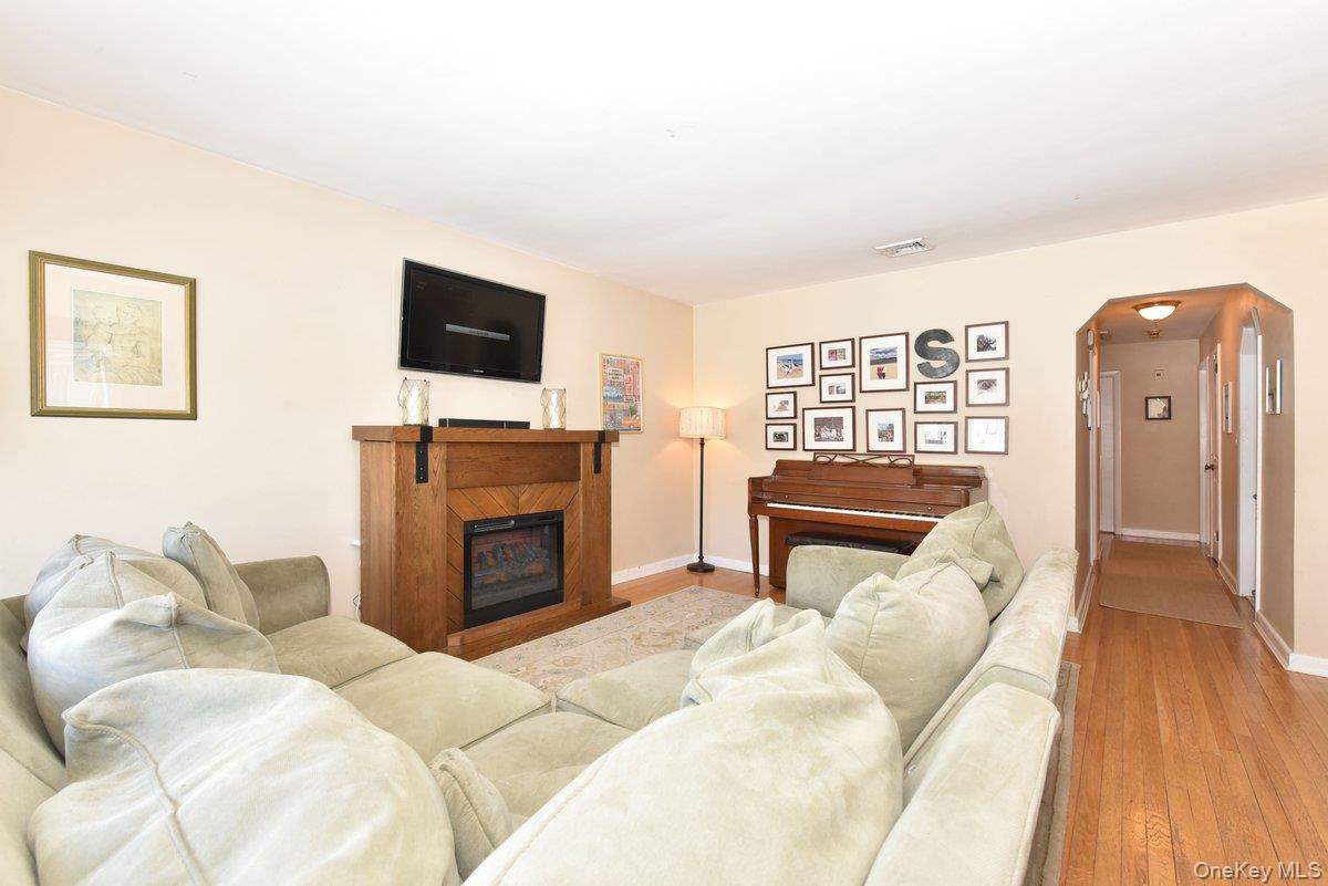 148 Simonson Road Mineola, NY 11501 - Photo 3 of 19 a bedroom with furniture and a flat screen tv