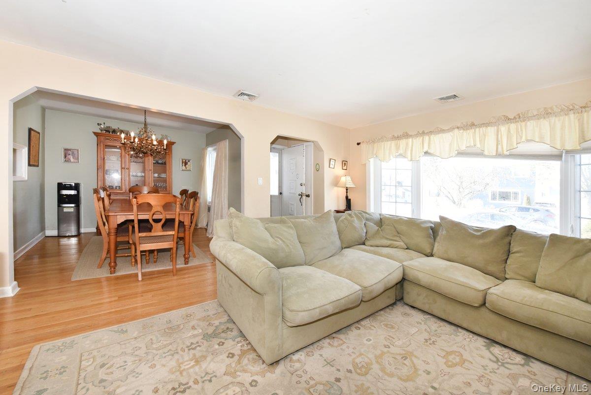 148 Simonson Road Mineola, NY 11501 - Photo 6 of 19 a living room with furniture and a large window