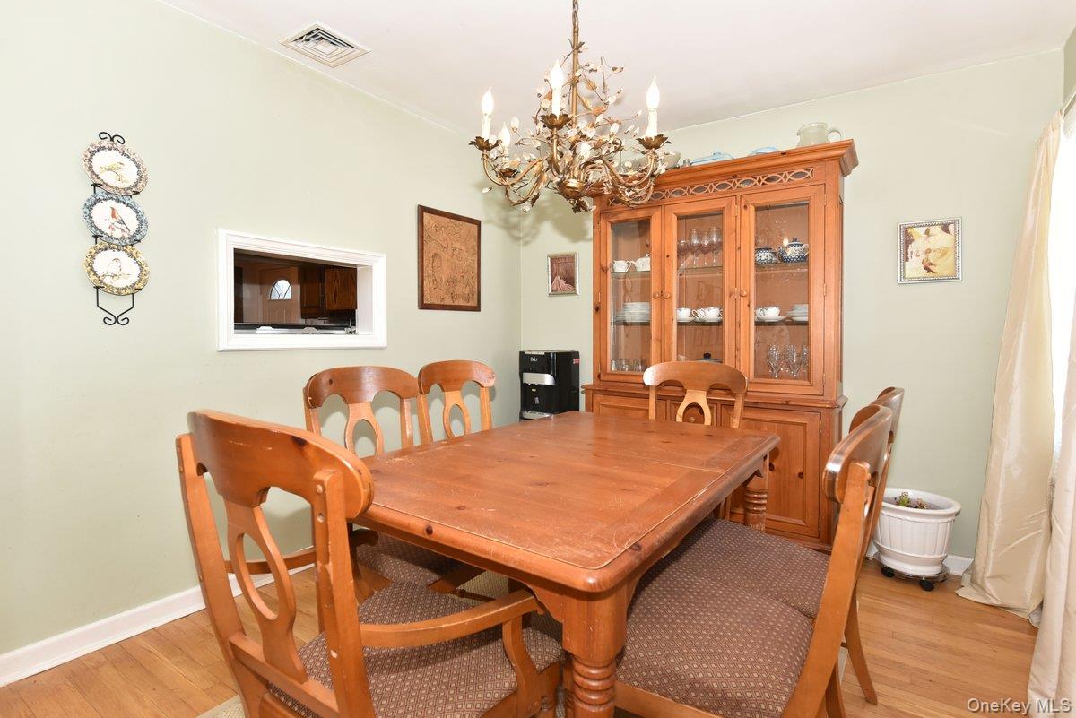 148 Simonson Road Mineola, NY 11501 - Photo 7 of 19 a view of a dining room with furniture and chandelier
