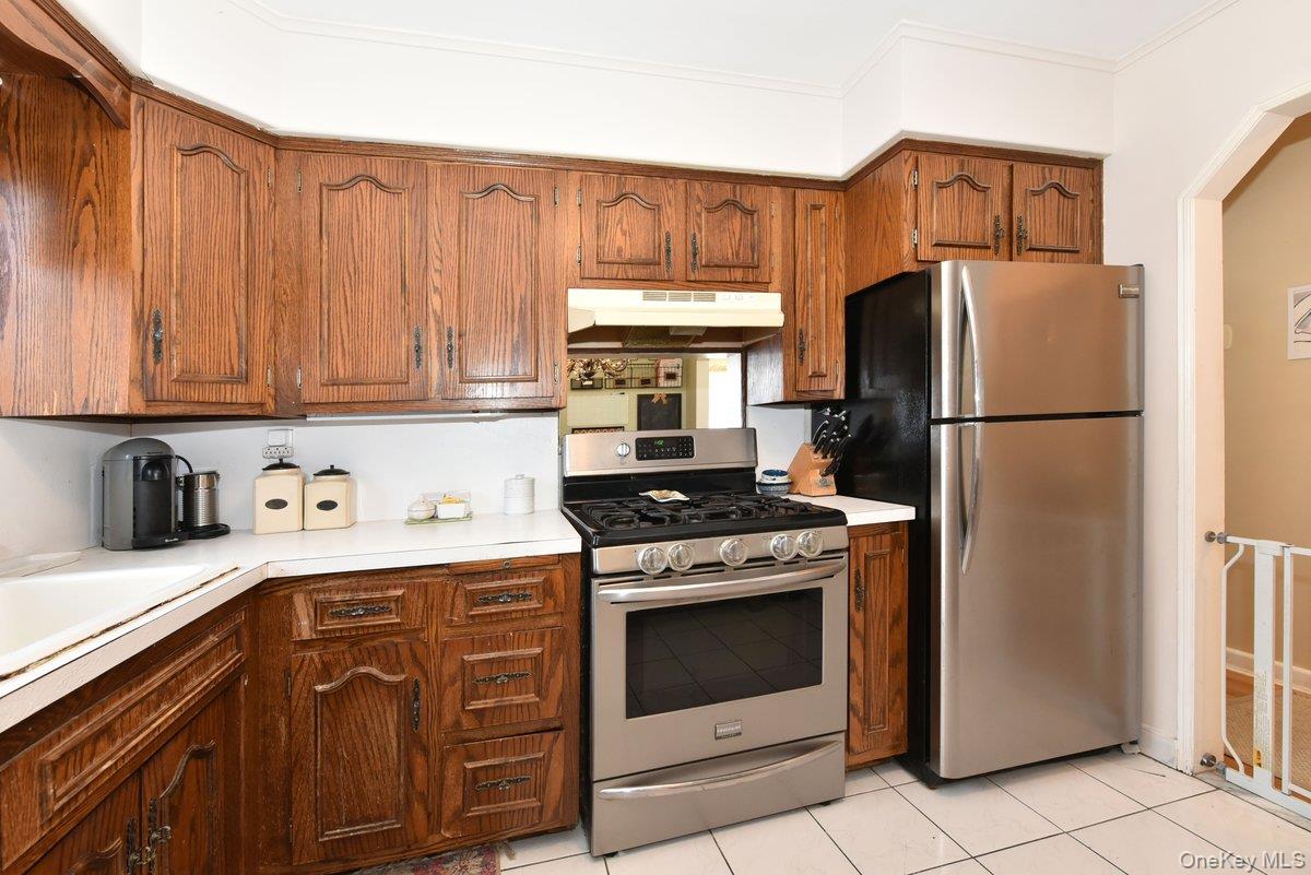 148 Simonson Road Mineola, NY 11501 - Photo 9 of 19 a kitchen with a stove refrigerator and cabinets