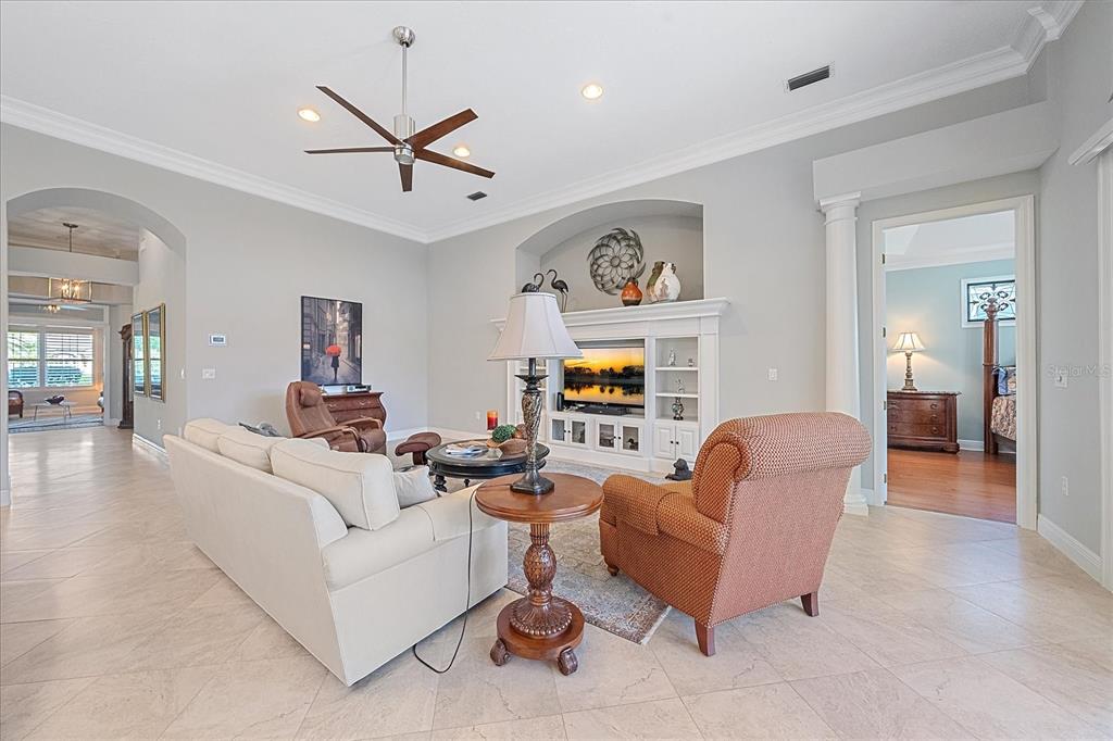 7825 Troon Court Lakewood Ranch, FL 34202 - Photo 11 of 40 a living room with furniture kitchen view and a window