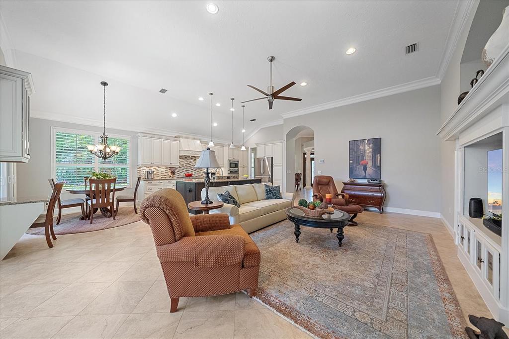 7825 Troon Court Lakewood Ranch, FL 34202 - Photo 12 of 40 a living room with furniture and a chandelier