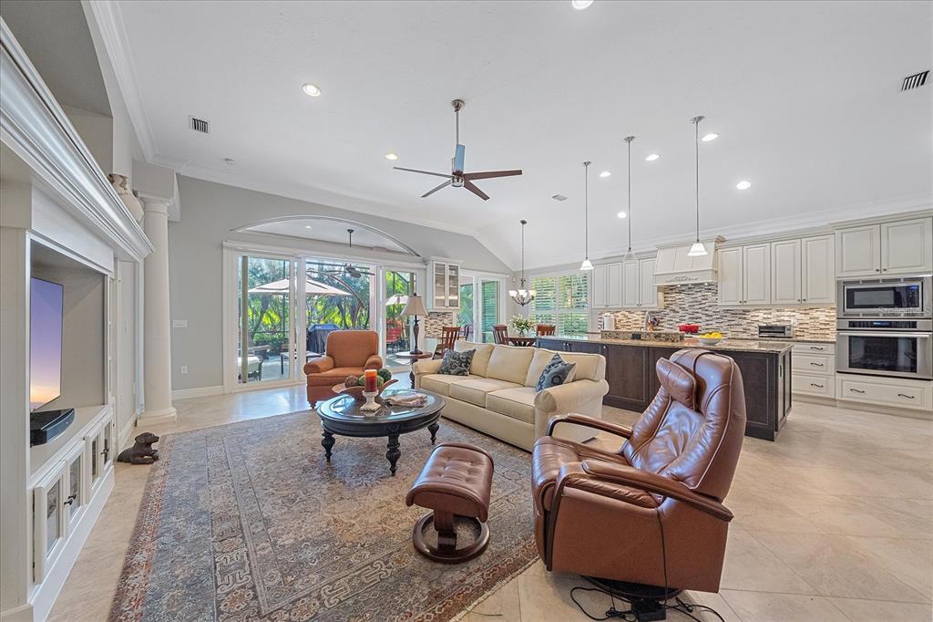 7825 Troon Court Lakewood Ranch, FL 34202 - Photo 13 of 40 a living room with furniture and a flat screen tv