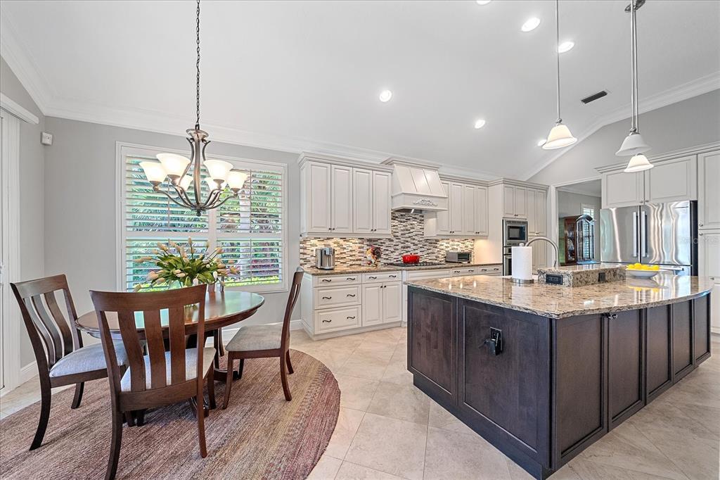 7825 Troon Court Lakewood Ranch, FL 34202 - Photo 15 of 40 a kitchen with granite countertop counter space a sink appliances and cabinets
