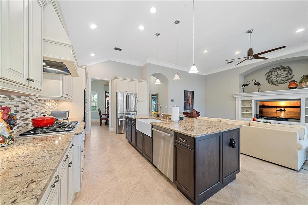 7825 Troon Court Lakewood Ranch, FL 34202 - Photo 17 of 40 a kitchen with stainless steel appliances granite countertop a stove and cabinets