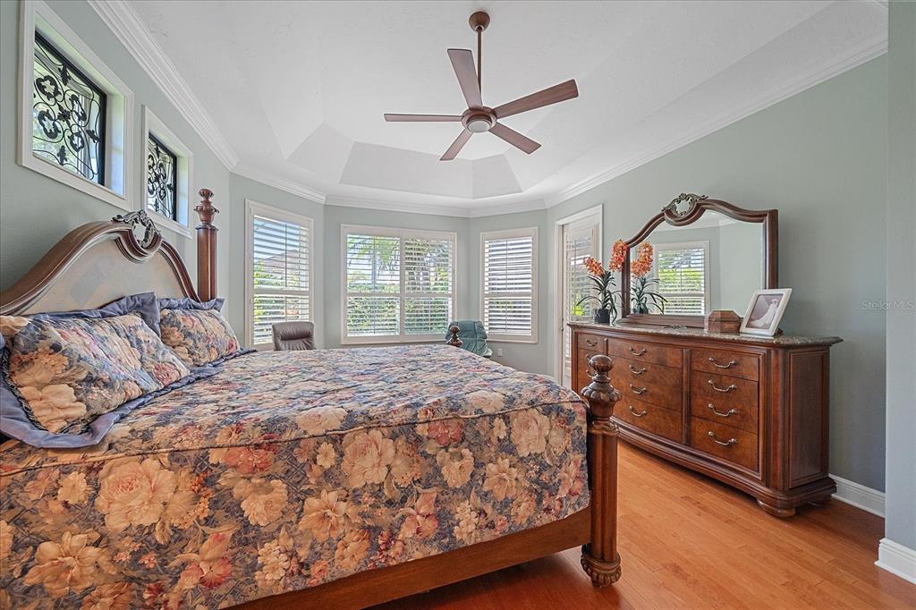 7825 Troon Court Lakewood Ranch, FL 34202 - Photo 23 of 40 a bedroom with a bed and a dresser in it