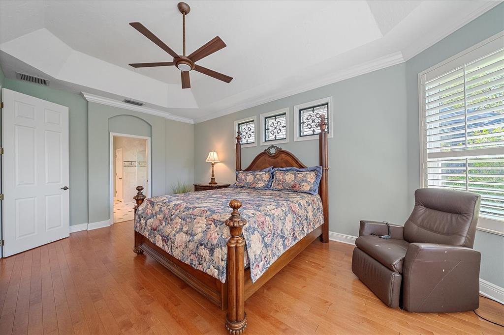 7825 Troon Court Lakewood Ranch, FL 34202 - Photo 24 of 40 a bedroom with a bed couch and window