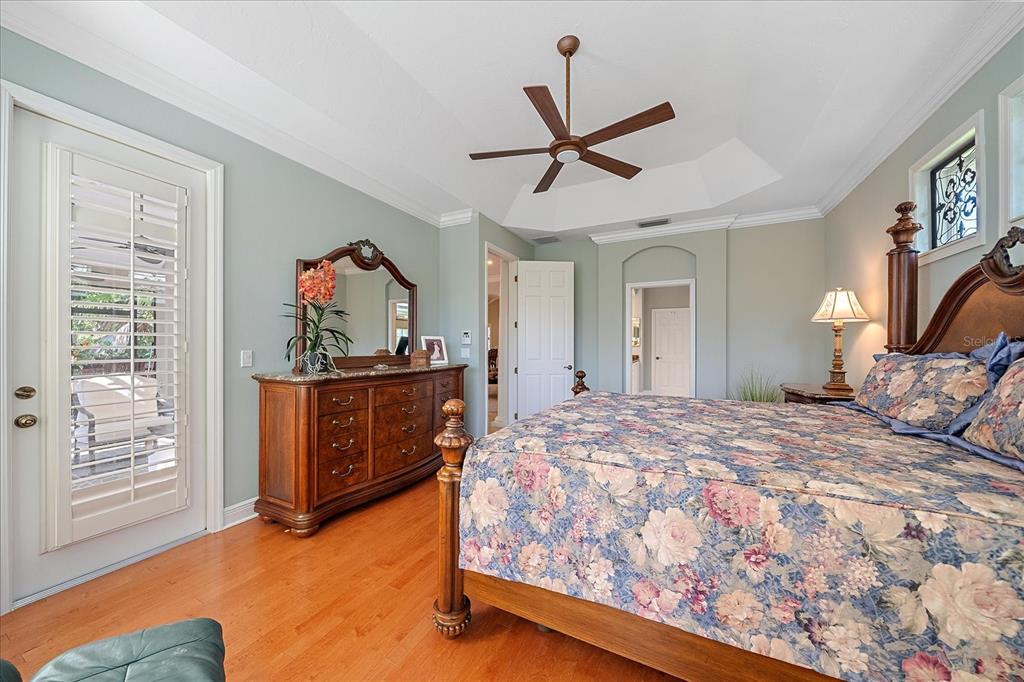 7825 Troon Court Lakewood Ranch, FL 34202 - Photo 25 of 40 a bedroom with a bed and a dresser