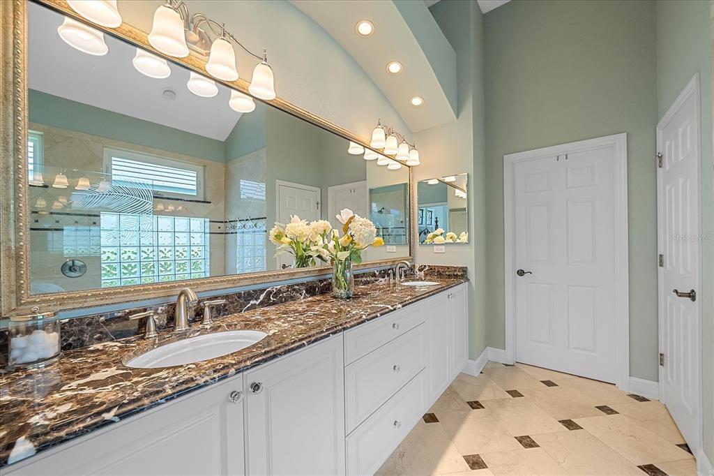 7825 Troon Court Lakewood Ranch, FL 34202 - Photo 26 of 40 a bathroom with a sink and a mirror