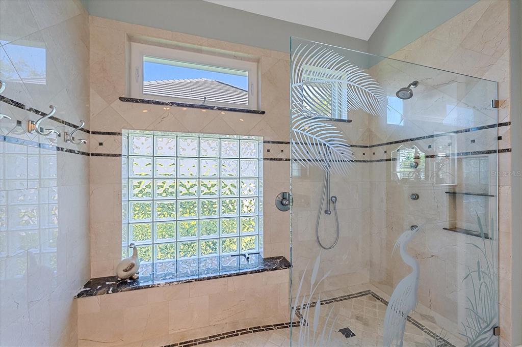 7825 Troon Court Lakewood Ranch, FL 34202 - Photo 27 of 40 a bathroom with a bathtub and shower