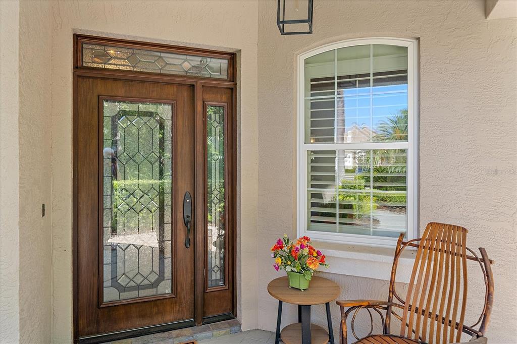 7825 Troon Court Lakewood Ranch, FL 34202 - Photo 3 of 40 a view of a dining room with a table and chairs
