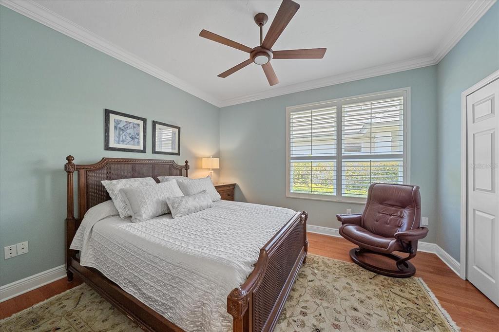 7825 Troon Court Lakewood Ranch, FL 34202 - Photo 31 of 40 a bedroom with a bed and chair