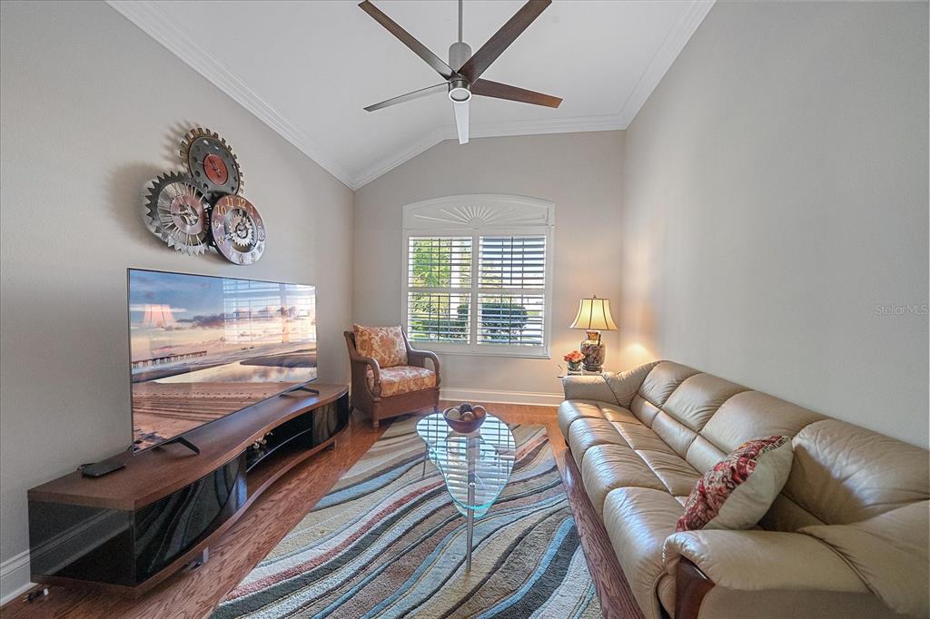 7825 Troon Court Lakewood Ranch, FL 34202 - Photo 32 of 40 a living room with furniture and a flat screen tv