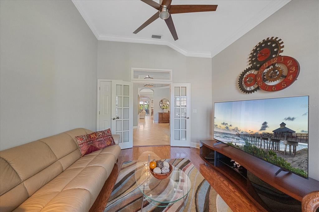 7825 Troon Court Lakewood Ranch, FL 34202 - Photo 33 of 40 a living room with furniture and wooden floor