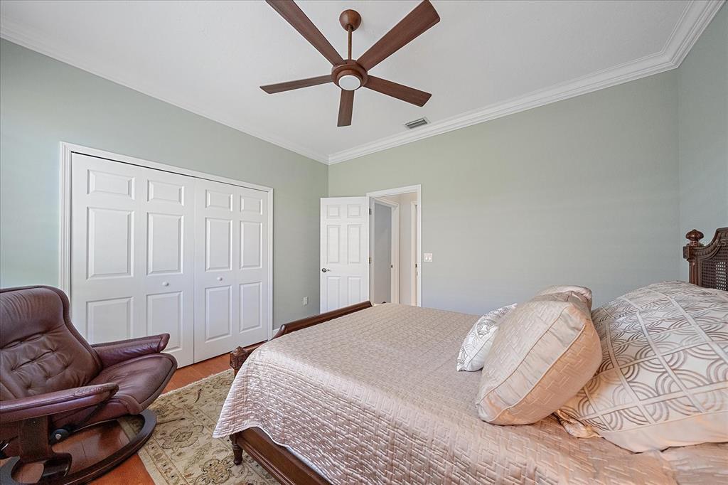 7825 Troon Court Lakewood Ranch, FL 34202 - Photo 34 of 40 a bedroom with a bed couch and a window