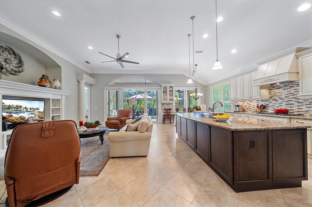 7825 Troon Court Lakewood Ranch, FL 34202 - Photo 9 of 40 a kitchen with stainless steel appliances granite countertop a stove and a living room