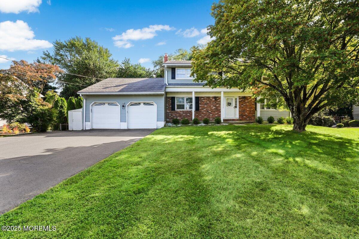 a view of a house with yard and a tree