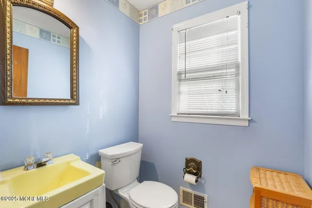 a bathroom with a toilet and a sink