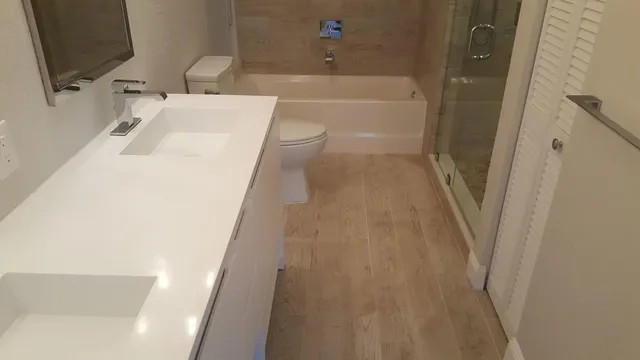 a bathroom with a sink a toilet and bathtub
