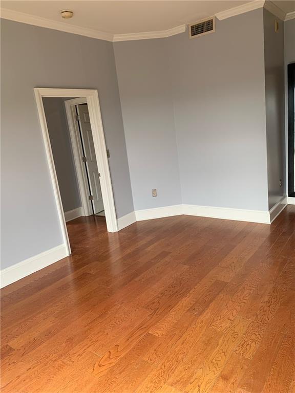 795 Hammond Drive, Unit 2105 Atlanta, GA 30328 - Photo 6 of 10 an empty room with wooden floor and closet
