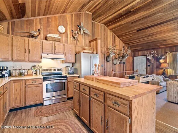 a kitchen with stainless steel appliances granite countertop a sink and cabinets