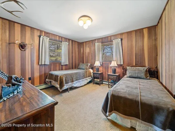 a bedroom with two beds and a dresser