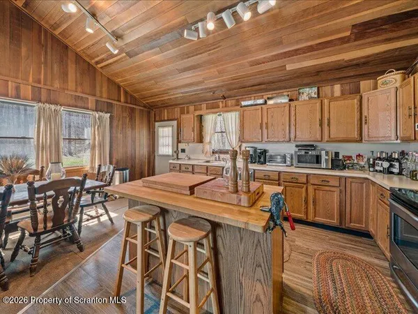 a kitchen with table chairs sink and cabinets