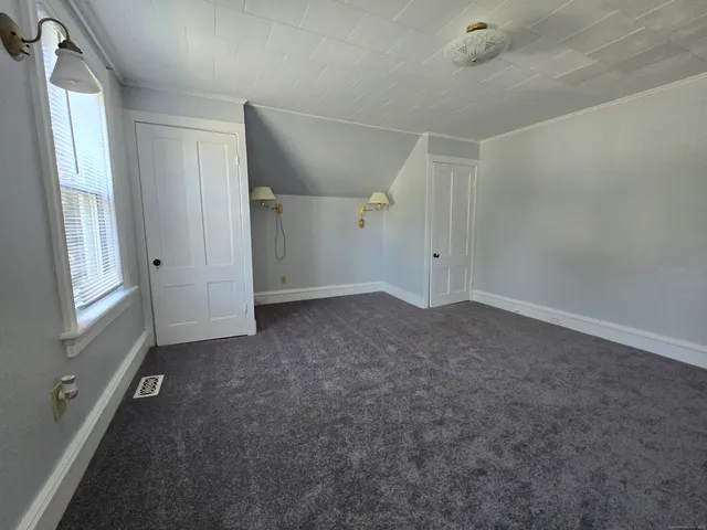 an empty room with windows and closet