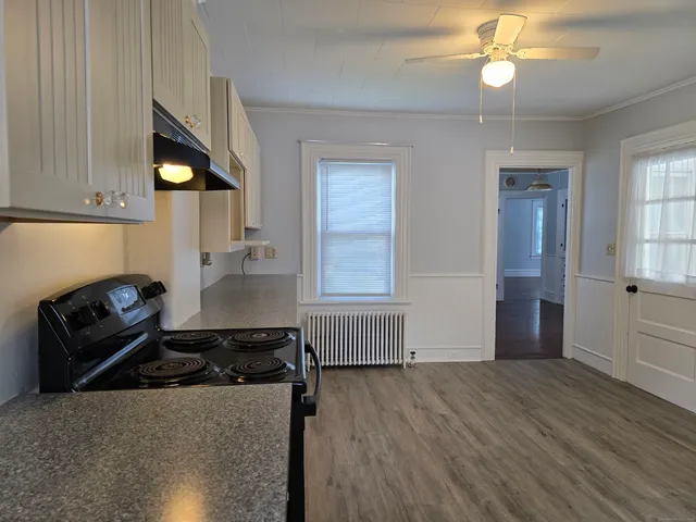 a kitchen with a refrigerator and a stove top oven